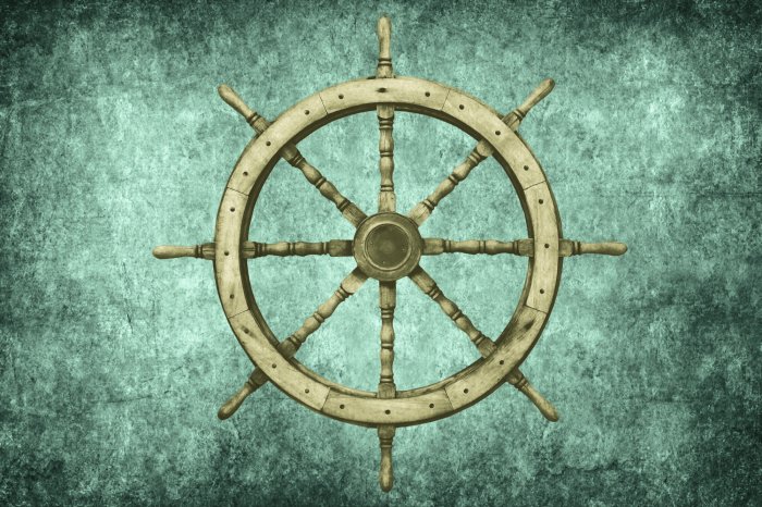 Fotobehang Een houten zeilroer rust op koel beton