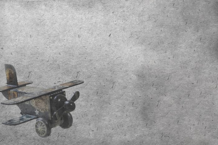 Fotobehang Houten model van een vliegtuig op de achtergrond