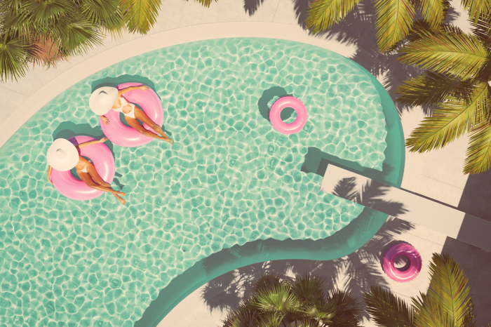 Canvas Bovenaanzicht van het zwembad en vrouwen in roze hoepels