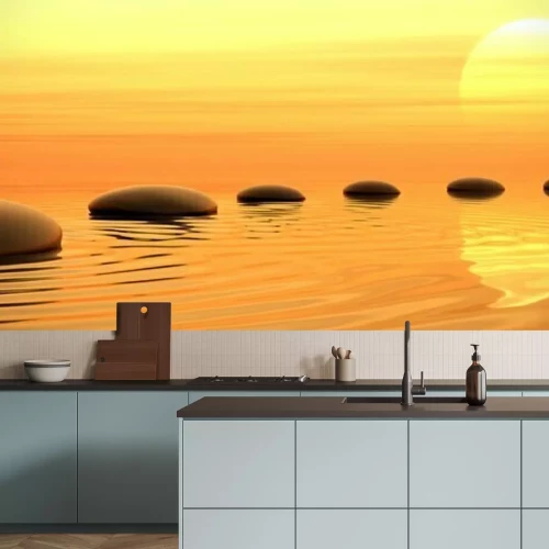 Sticker Ronde stenen in het water tegen de achtergrond van de ondergaande zon