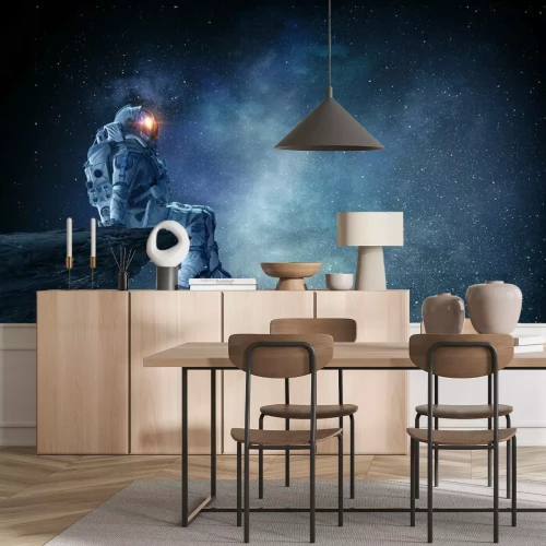 Fotobehang Astronaut zittend op een rots