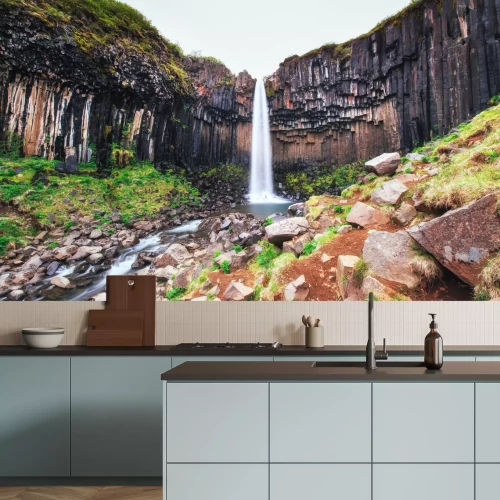 Fotobehang Landschap met een waterval tussen de rotsen