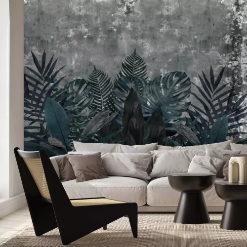 Fotobehang Blauwe tropische bladeren op een betonnen achtergrond