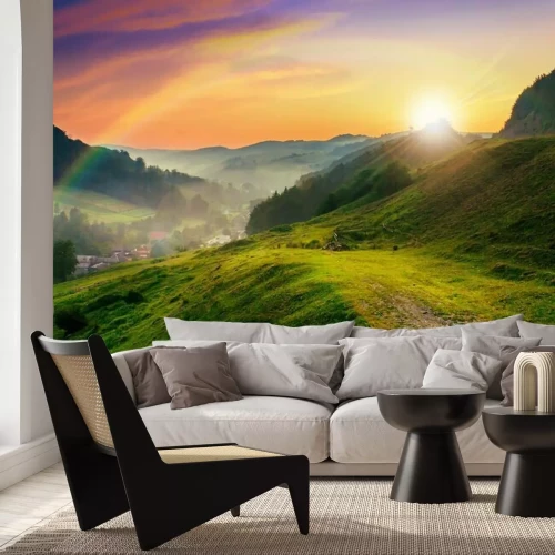 Fotobehang Regenboog over de groene heuvels