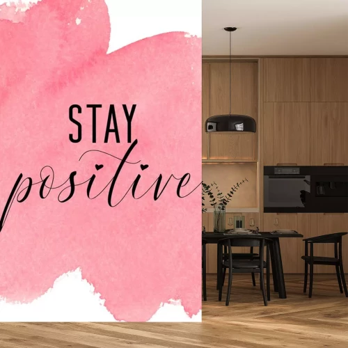 Sticker Stay positive. Inspiring quote with pink watercolor background