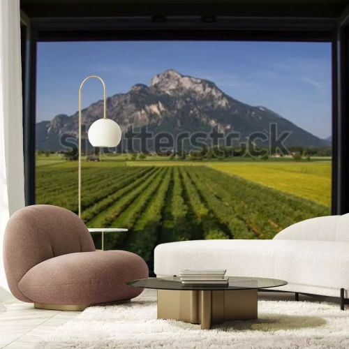 Fotobehang Uitzicht vanaf een open raam, van een berg, met een groen veld aan de voorkant