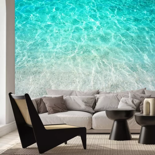 Sticker Een stuk turkoois water verlicht door de zon