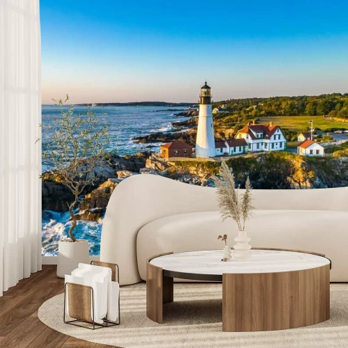 Fotobehang Een vuurtoren op een rots tegen een wolkenloze hemel