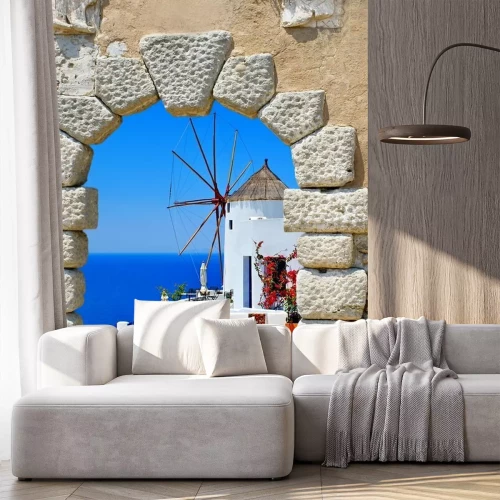 Fotobehang Uitzicht door het raam van een Griekse windmolen op Santorini