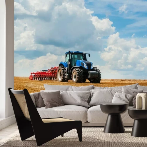 Fotobehang Blue tractor in the field, agricultural machinery work, field and beautiful sky