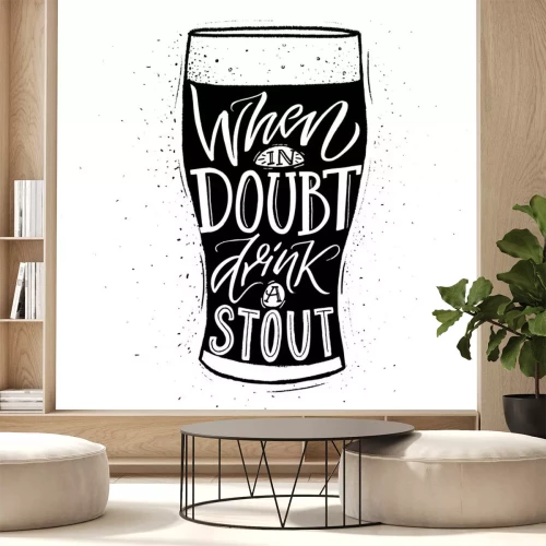 Sticker When in doubt, drink a stout. Funny inspirational quote about beer with hand lettering for pubs, bars and t-shirt design. Black and whiite typographic design.