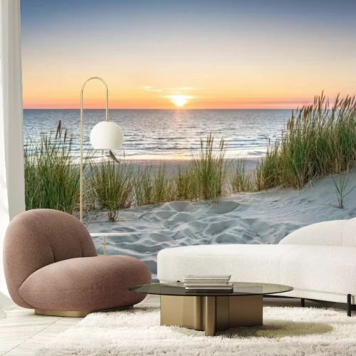 Fotobehang Zonsondergang over de zee en een zandstrand