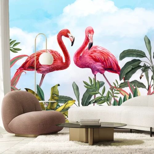 Fotobehang Flamingo's tussen tropische bladeren tegen blauwe lucht