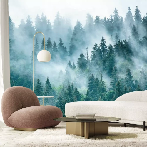 Fotobehang Mistig landschap met bos op de heuvels