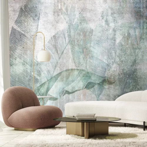 Fotobehang Een groot bananenblad op een grijze betonnen muur