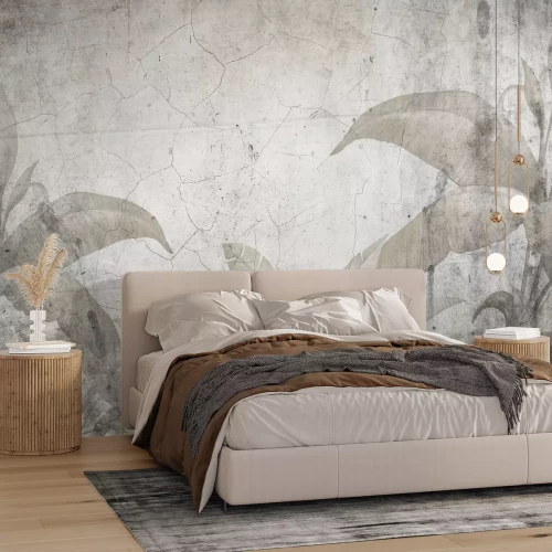 Fotobehang Tropische planten tegen een achtergrond van gebarsten beton