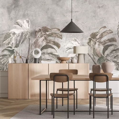 Fotobehang Grote monsterabladeren op beton, botanisch patroon