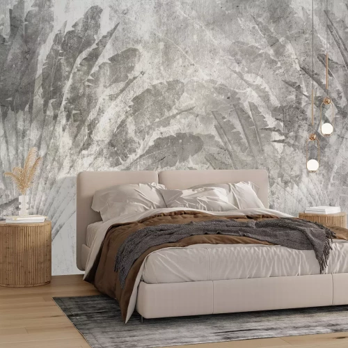 Fotobehang Grote grijze tropische bladeren op beton