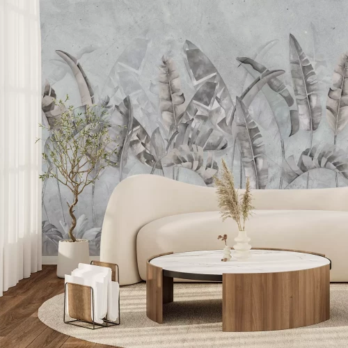 Fotobehang Bananen- en monsterabladeren op een betonnen achtergrond