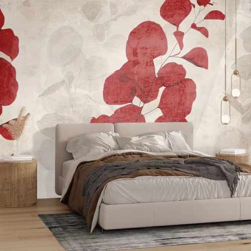 Fotobehang Rode en beige bladeren tegen een betonnen achtergrond