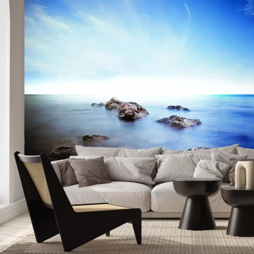 Fotobehang Rotsachtige stenen aan de kust