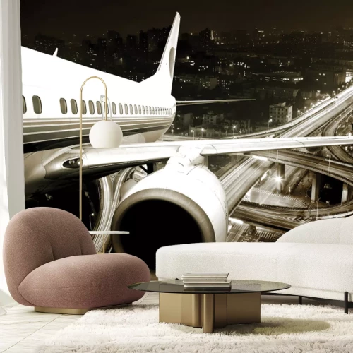 Fotobehang Een vliegtuig boven de stad 's nachts