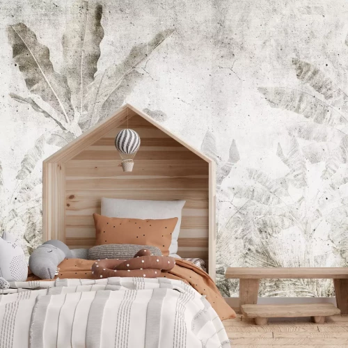 Fotobehang Bananenbladeren op een betonnen muur in een urban jungle-stijl.