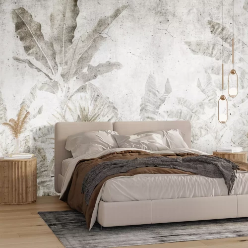 Fotobehang Bananenbladeren op een betonnen muur in een urban jungle-stijl.