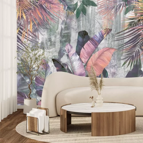 Fotobehang Kleurrijke palm- en bananenbladeren op een betonnen achtergrond