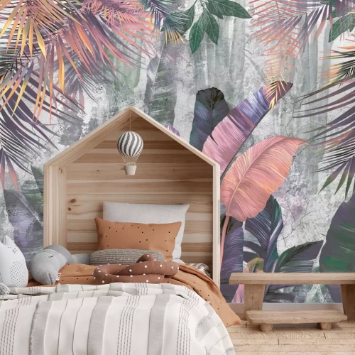 Fotobehang Kleurrijke palm- en bananenbladeren op een betonnen achtergrond