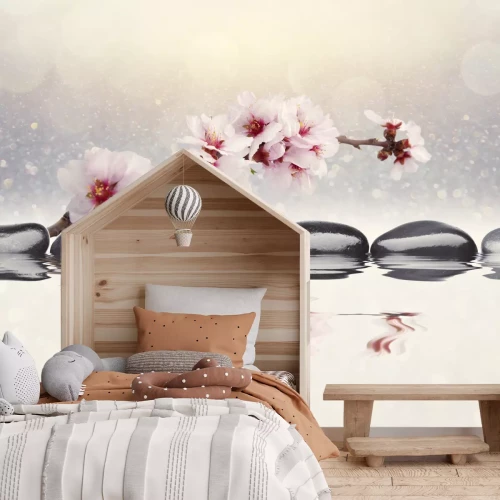 Fotobehang Roze orchidee en zenstenen weerspiegeld in het water