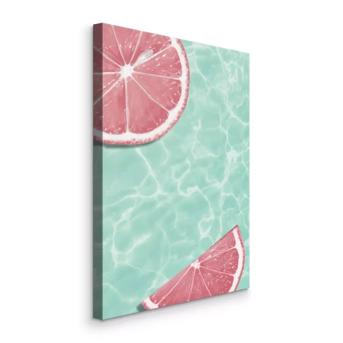 Canvas Grapefruitschijfjes tegen een achtergrond van turquoise water