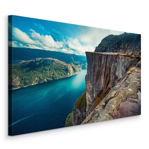 Canvas Een rivier die onder een rotsachtige klif stroomt