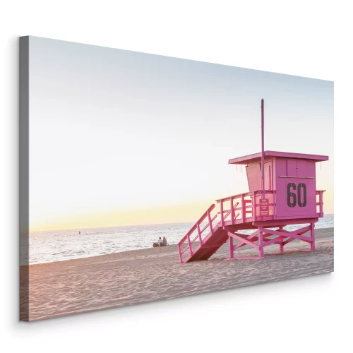 Canvas Een pastelkleurige strandwachtpost met uitzicht op de oceaan bij zonsopgang