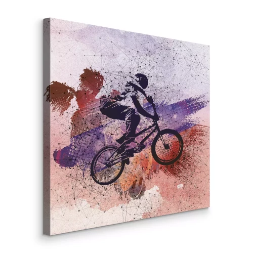 Canvas Dynamische fietssprong tegen een abstracte achtergrond
