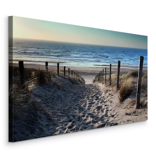 Canvas Een zandpad richting de blauwe golven van de zee