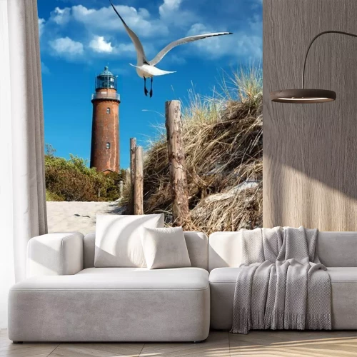 Fotobehang Vuurtoren aan de kust en een meeuw