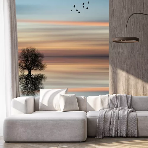 Sticker Silhouet van een boom in het water tijdens zonsondergang