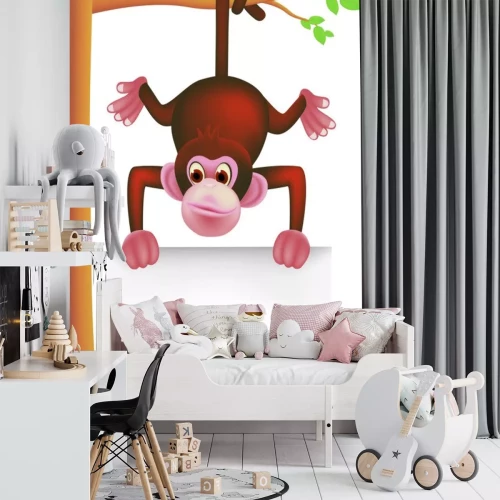 Sticker Een kleine bruine aap die aan een tak hangt