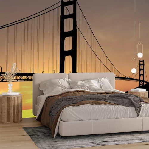 Fotobehang Hangbrug met zonsondergang op de achtergrond