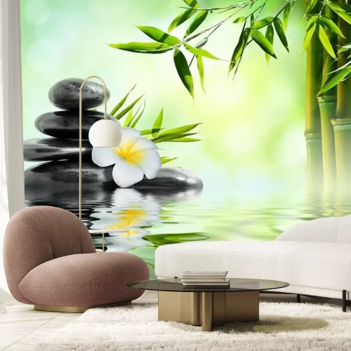 Sticker Zwarte stenen met plumeria en bamboe ondergedompeld in water