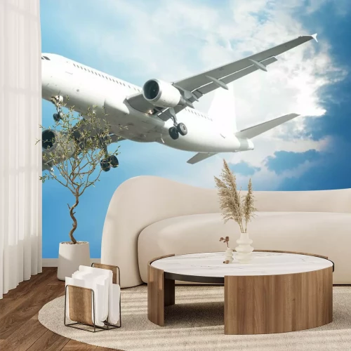Fotobehang Een vliegtuig in de blauwe lucht