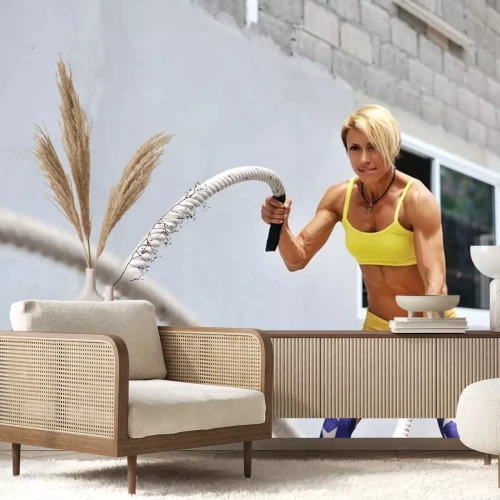 Sticker Athletic young woman doing some crossfit exercises with a rope o