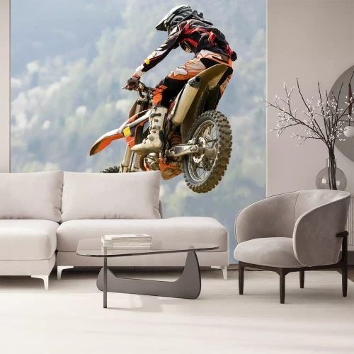 Fotobehang Een motorrijder die een motorcrosssprong maakt