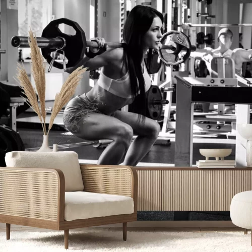 Fotobehang Fitness vrouw die gewichten heft