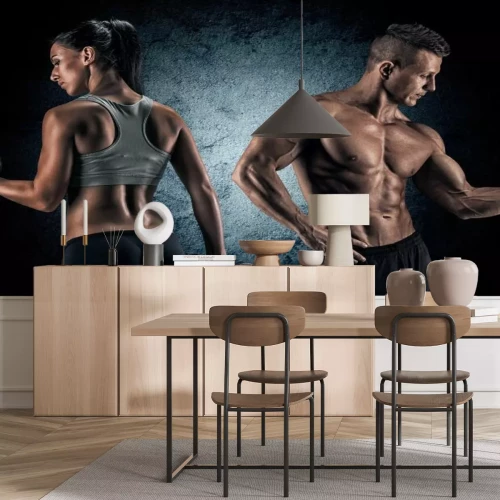 Fotobehang Atletisch stel met gewichten in de sportschool