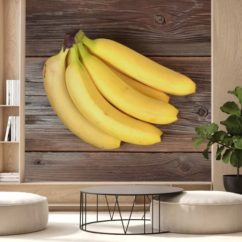 Sticker Een tros bananen op een houten ondergrond