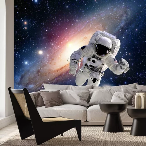 Fotobehang Een astronaut vliegt door de ruimte tegen een achtergrond van sterren