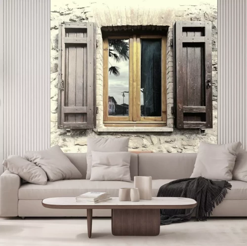Fotobehang Een raam met luiken in een stenen huis