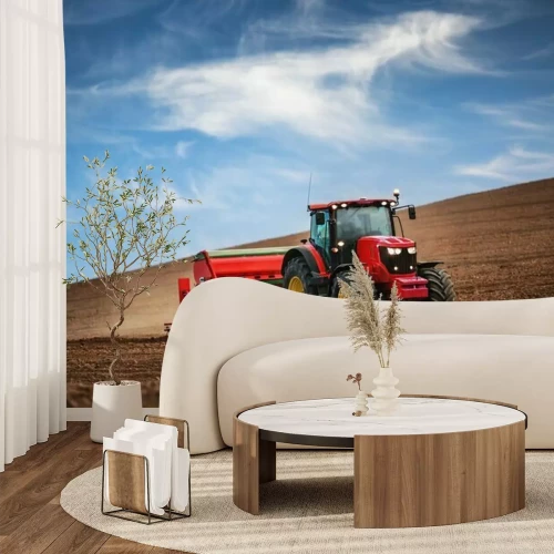Fotobehang Rode tractor op het veld